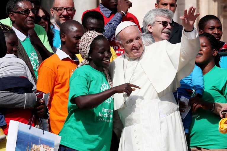 Pope Francis meets with Caritas Internationalis Secretary General Michel Roy accompanied by a group of migrants and refugees in Vatican City on Sept. 27, 2017. Photo taken by Grzegorz Galazka/Archivio Grzegorz Galazka/Mondadori Portfolio via Getty Images.